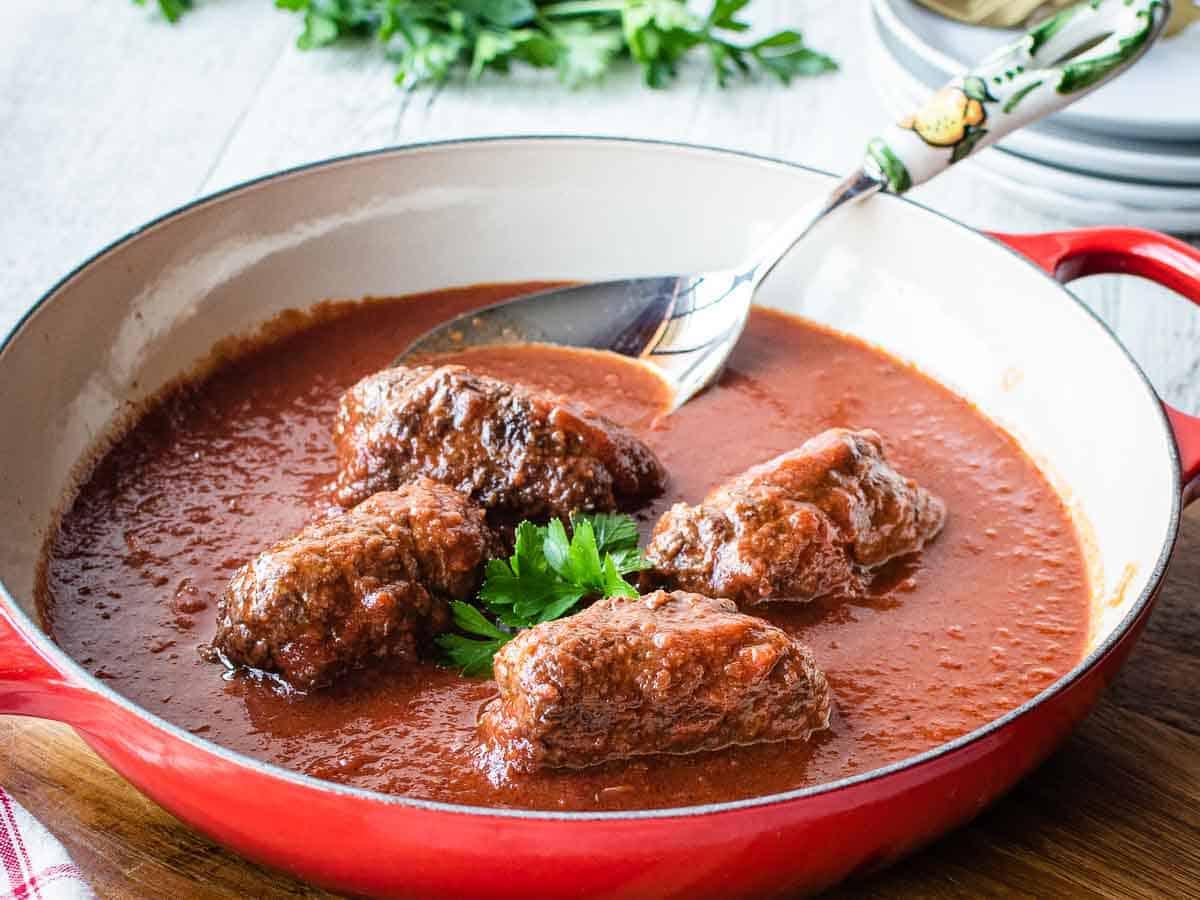 finished beef braciole with tomato sauce in a bowl