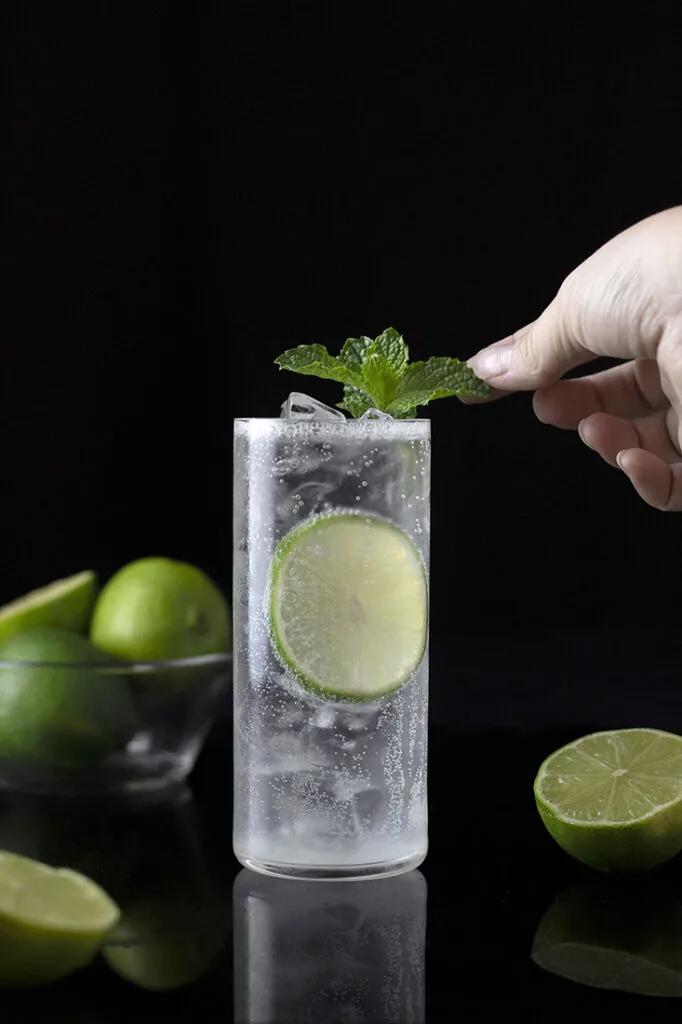 Person enjoying a Gin Rickey outdoors