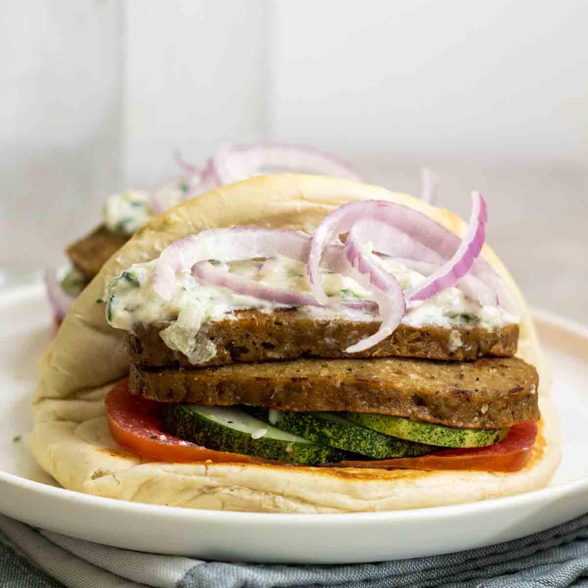 A stack of freshly made seitan slices, ready to be sautéed for the gyros