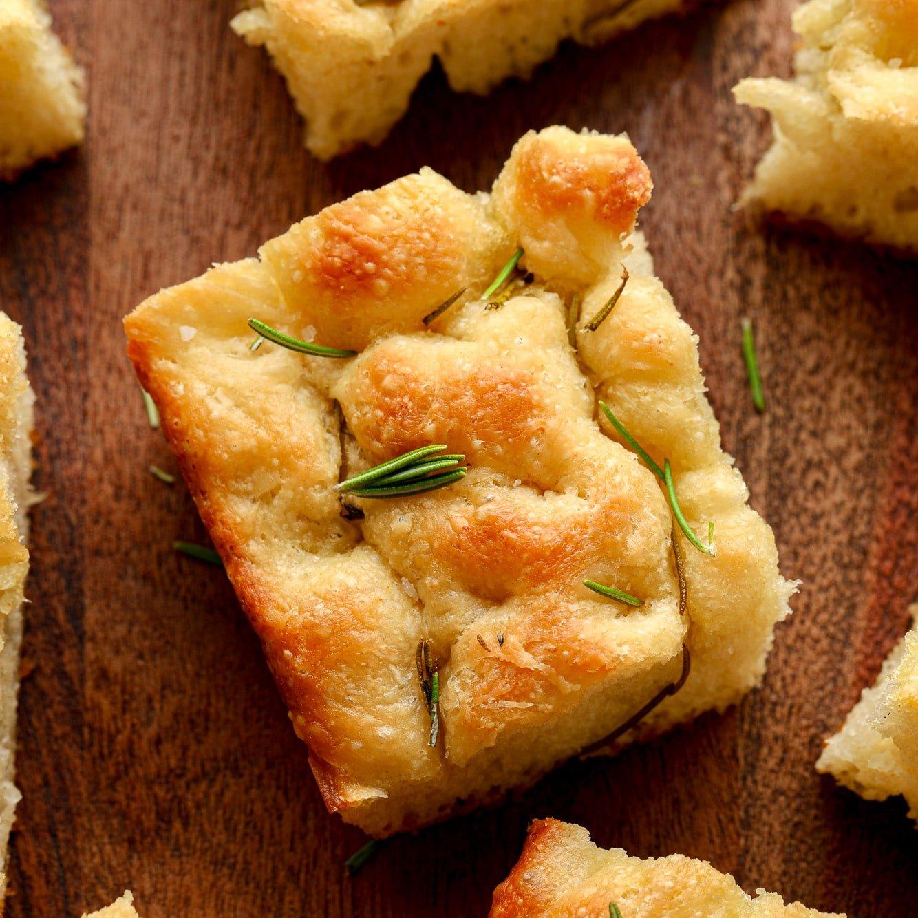 Vegan focaccia bread with vegan herbs and vegan cheese, close-up shot