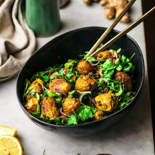 bowl of cumin and curry potato salad on a picnic blanket