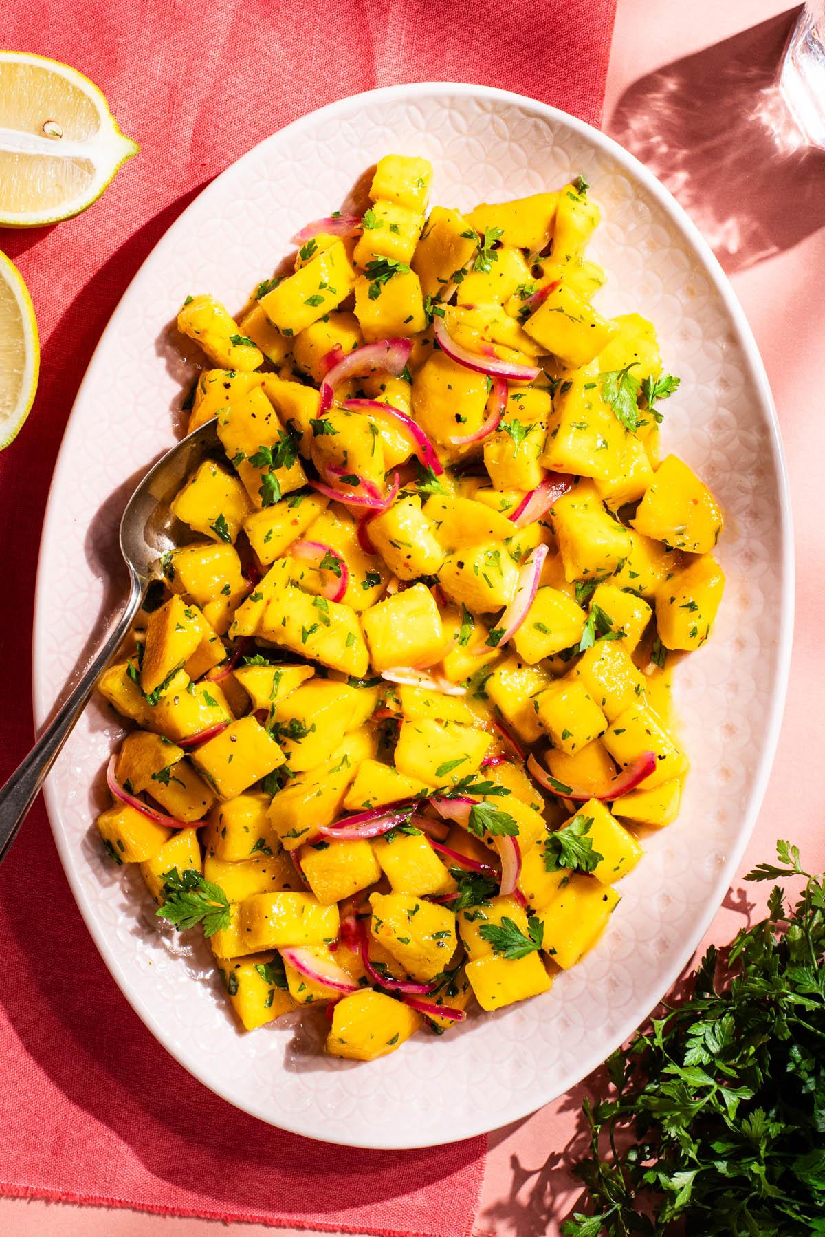 Close-up shot of a colorful Spicy Mango Fattoush salad in a rustic bowl.