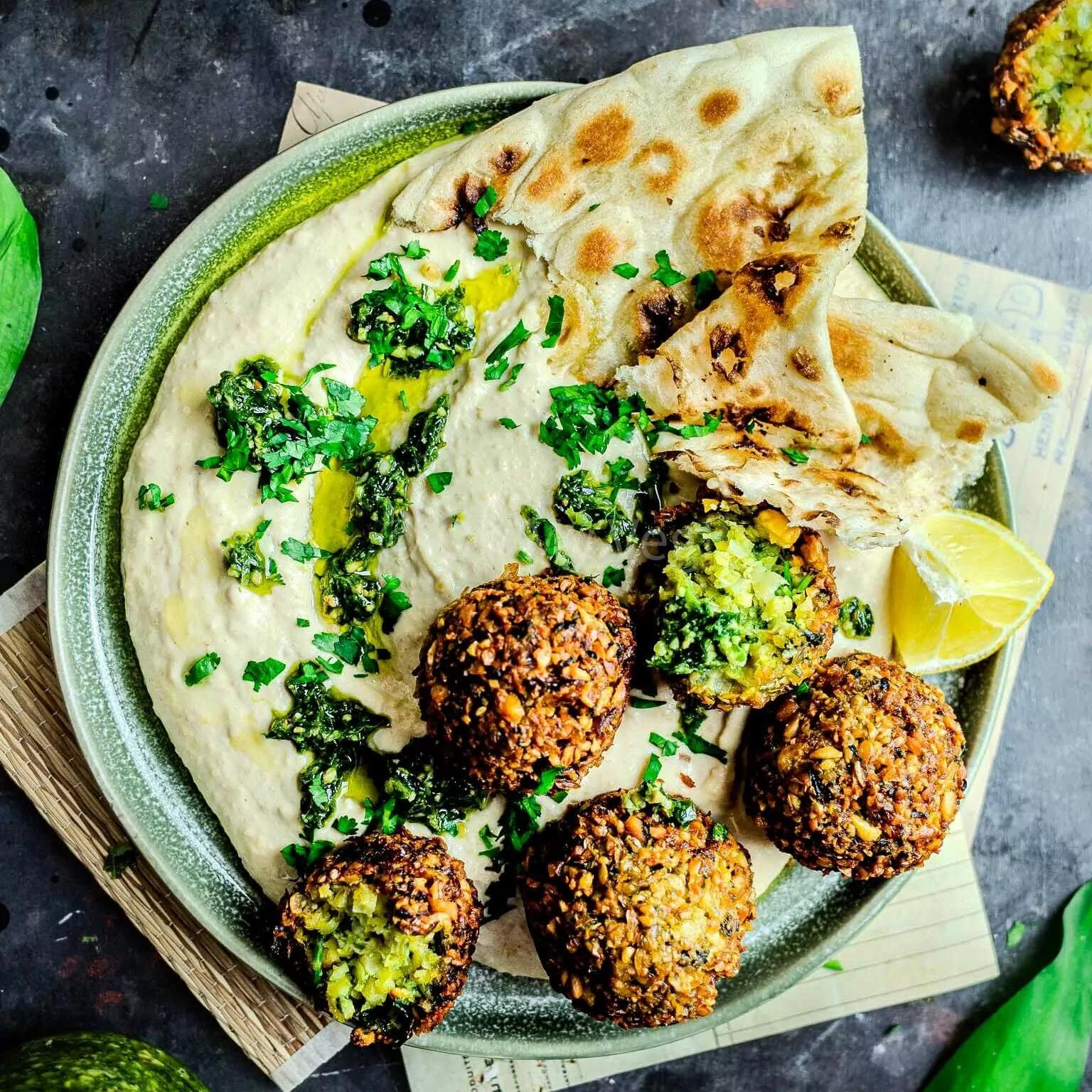 Plate of Smoked Paprika & Garlic Falafel with Aioli, garnished with fresh herbs