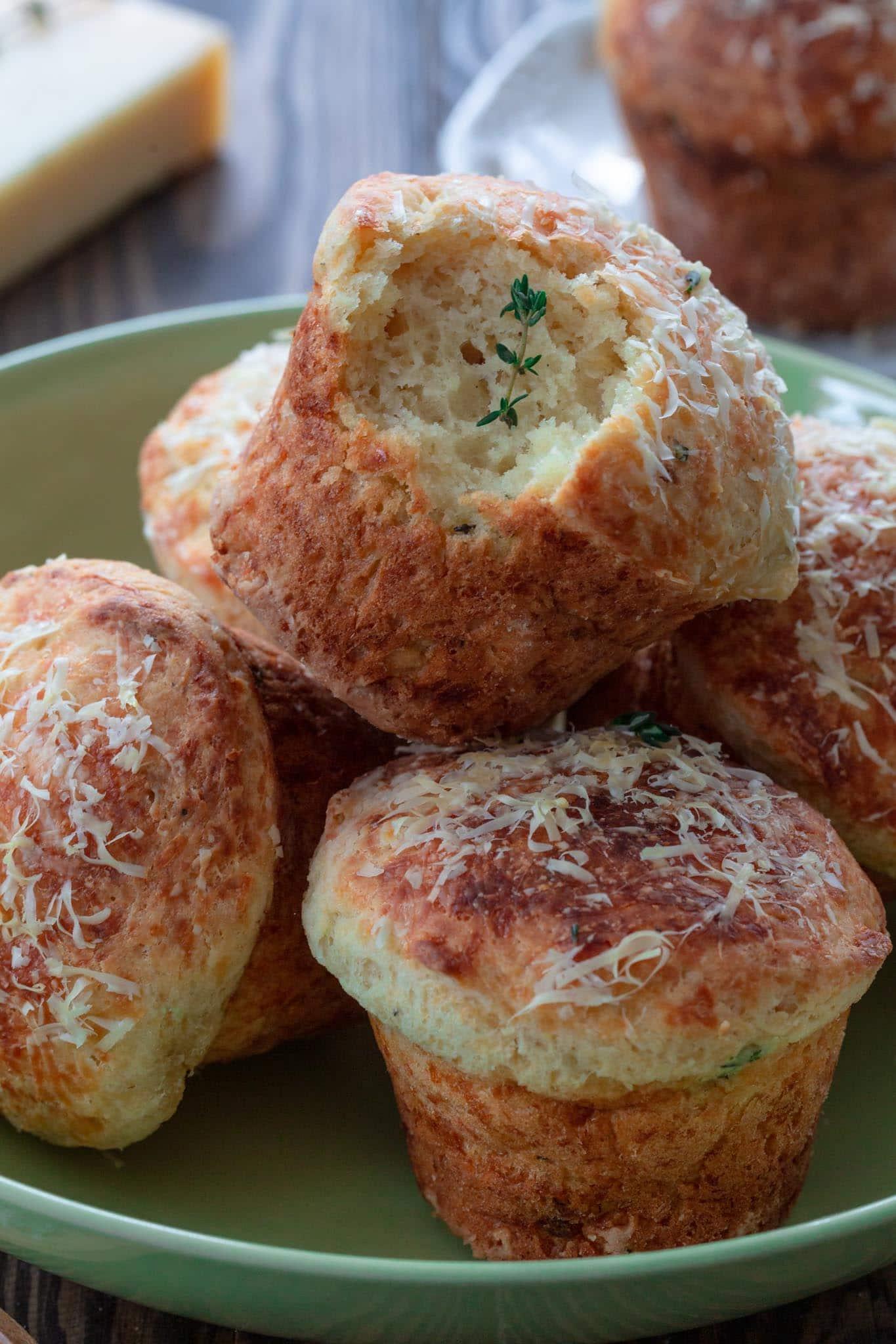 Close up shot of a single asiago and parmesan cheese muffin, showing its texture and color