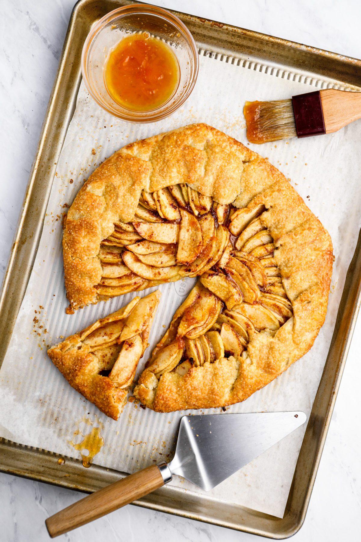Close up of a slice of apple cinnamon tart, showing the flaky crust and juicy apples
