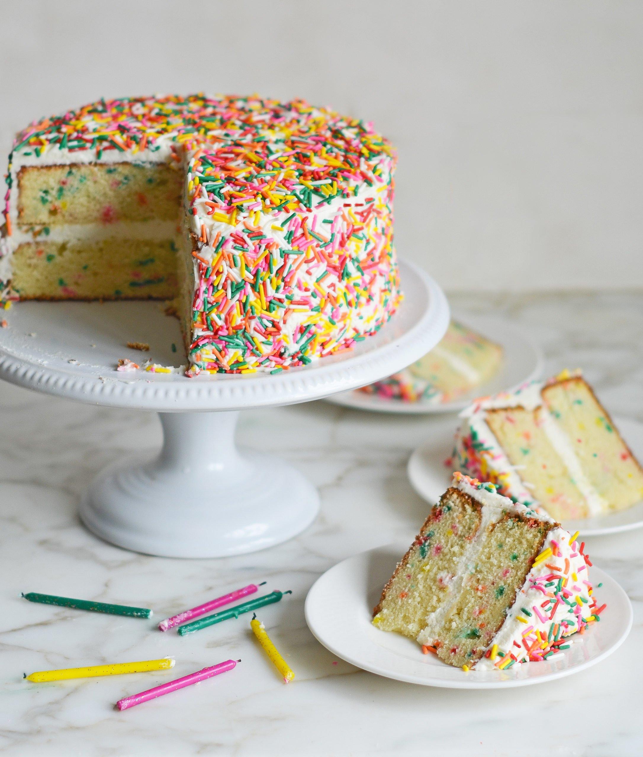 two delicious birthday cake loaf cakes freshly baked and decorated with buttercream frosting and sprinkles