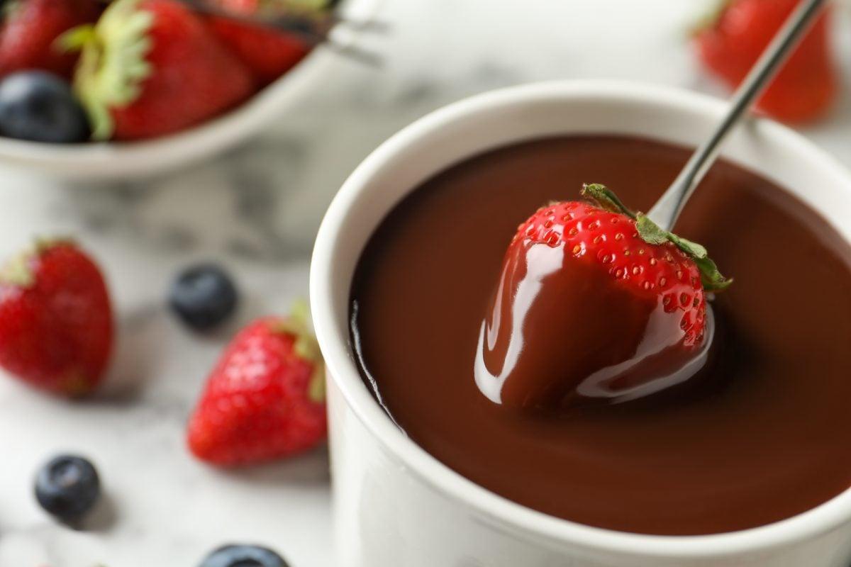 A close-up of melted chocolate fondue, smooth and rich in texture