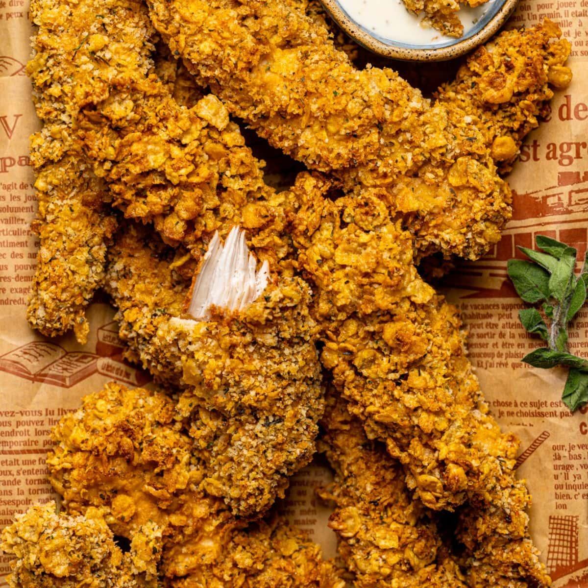 Close-up shot of crispy jerk chicken tenders on a baking sheet
