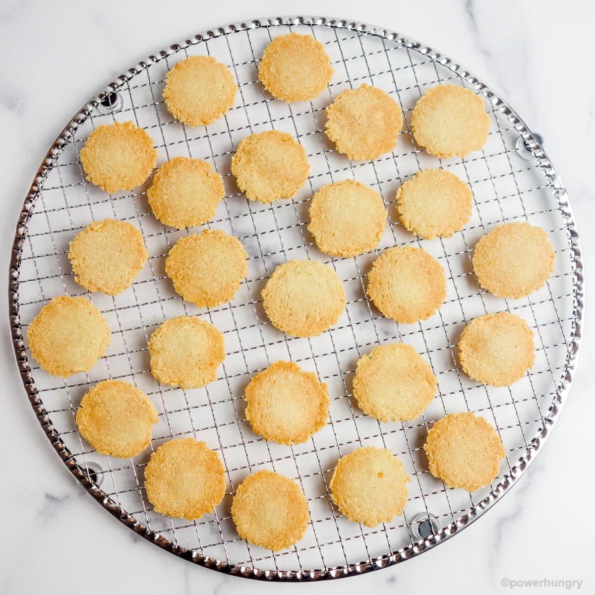 overhead shot of freshly baked saffron almond keto wafers on a cooling rack