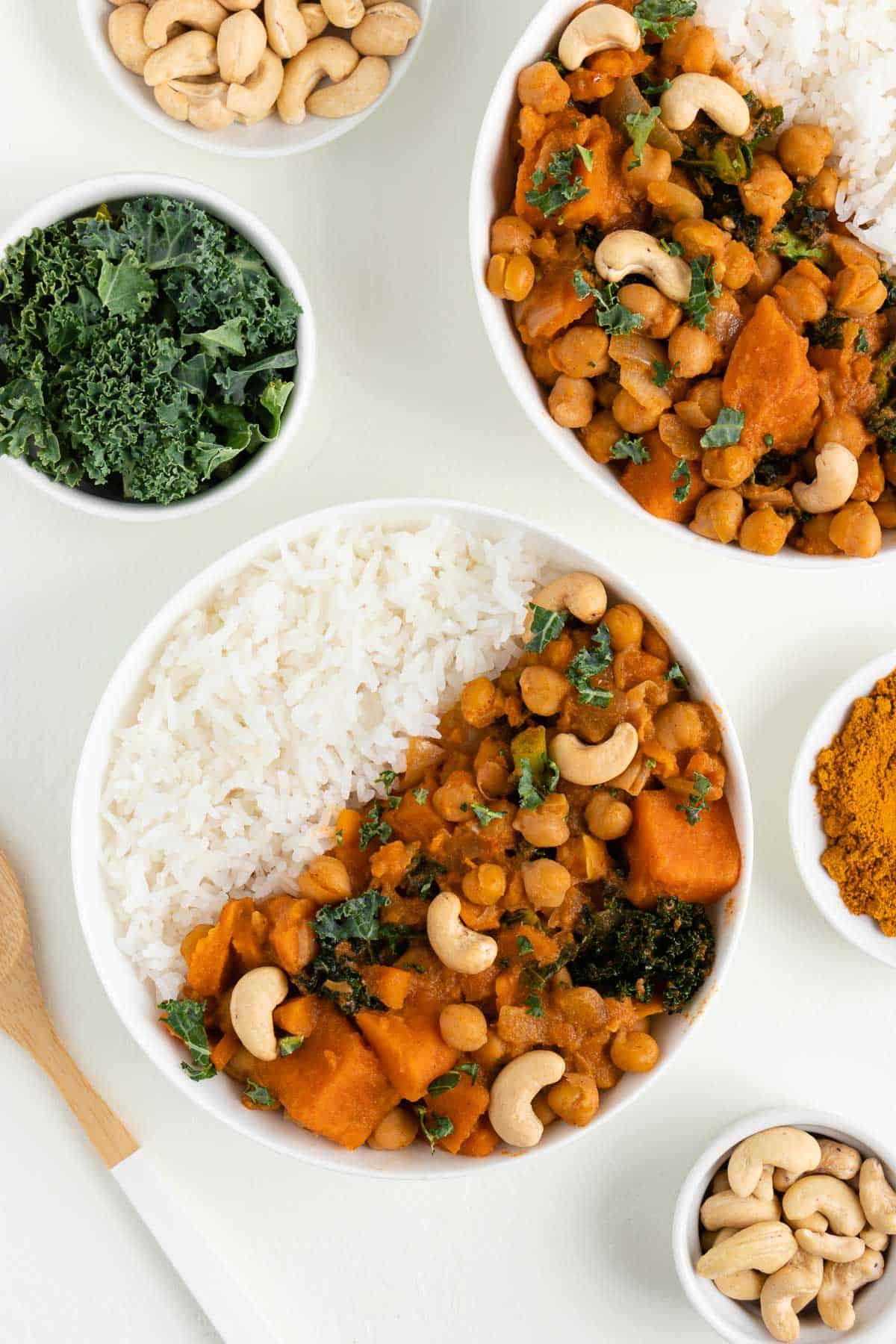 close up of the ingredients for the curry including kale sweet potato chickpeas and spices