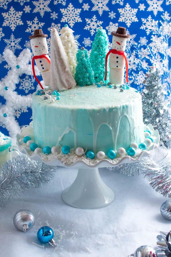 Whole winter wonderland birthday cake on a decorated table with winter themed decorations