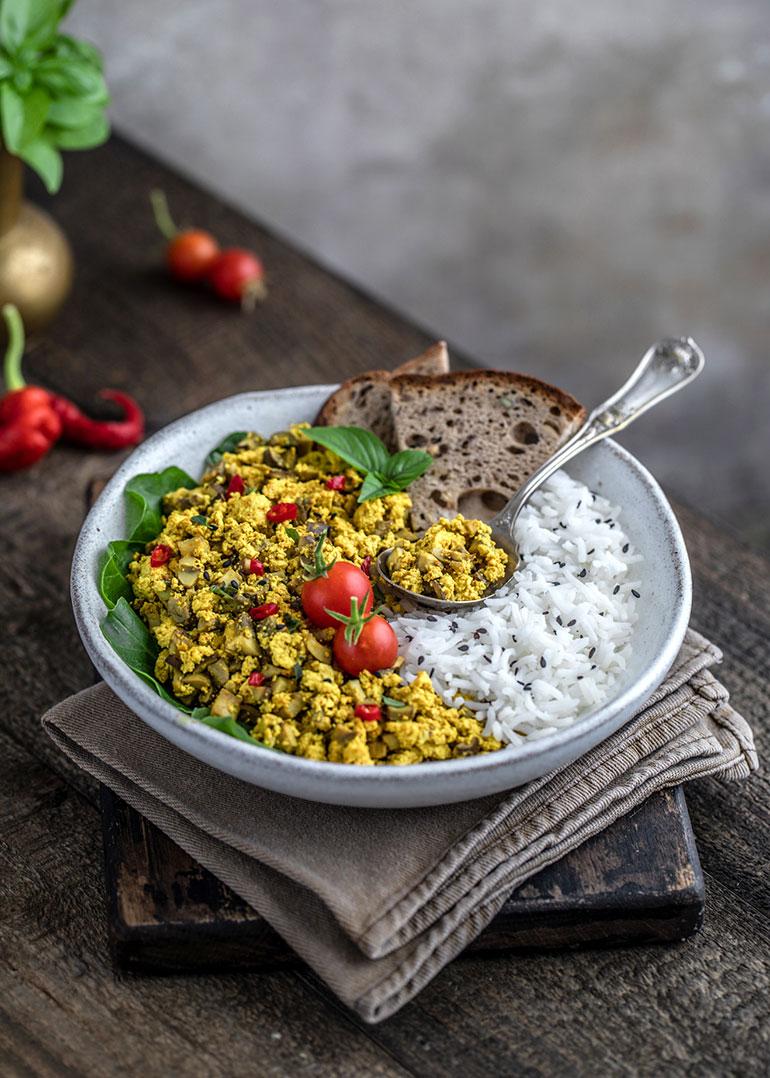 A mouthwatering image of tofu scramble with mushrooms and thyme, served in a rustic bowl or on a plate.