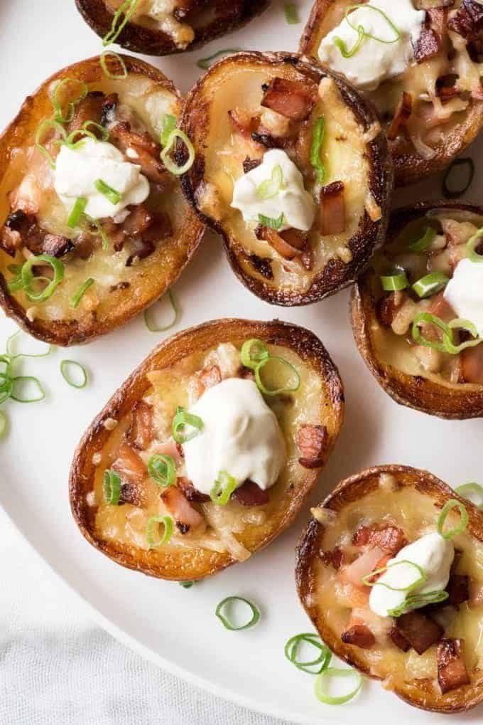 Close-up of a perfectly golden, crispy mini potato skin with melted cheese and bacon
