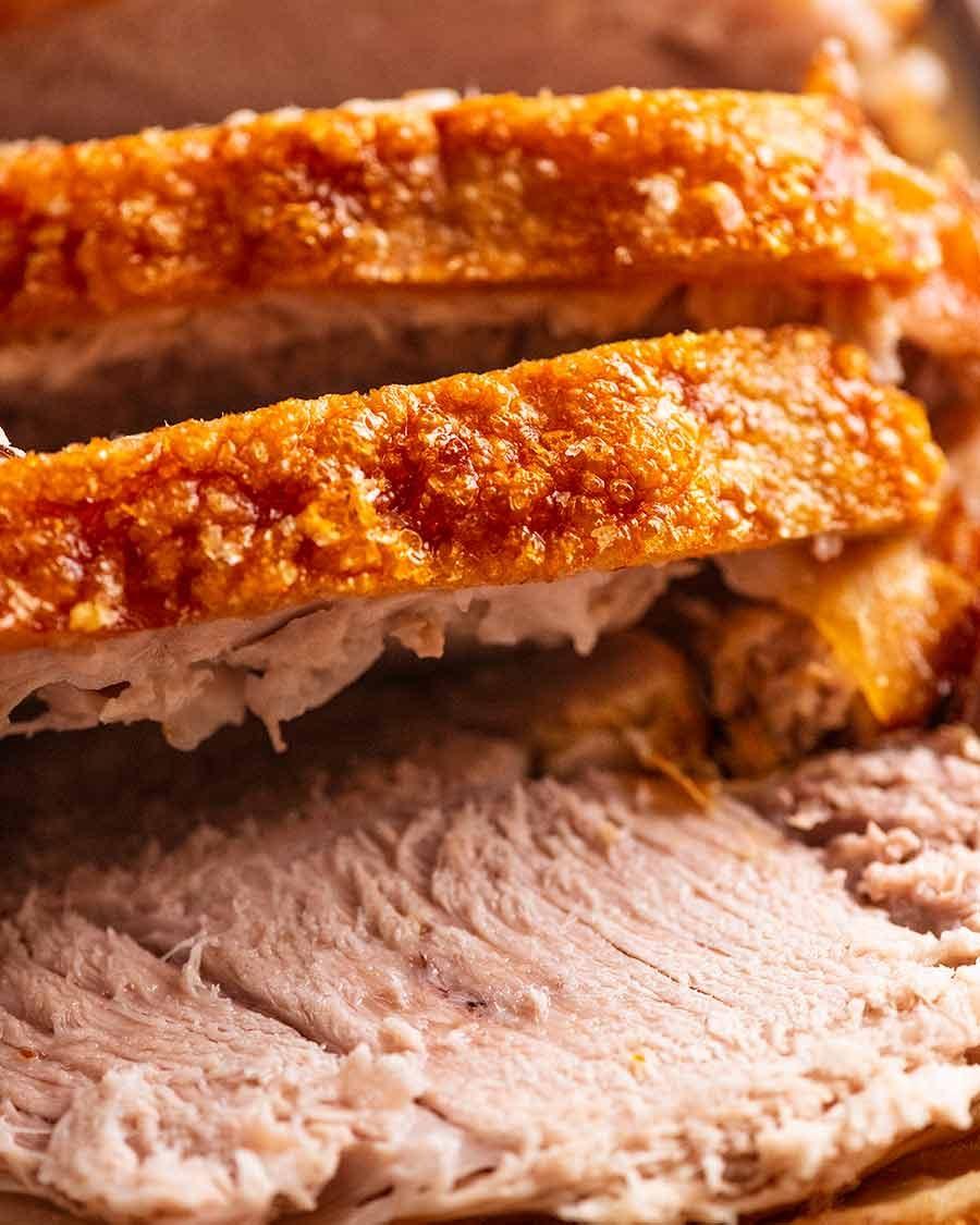 Close-up shot of a perfectly roasted pork roast with crispy skin