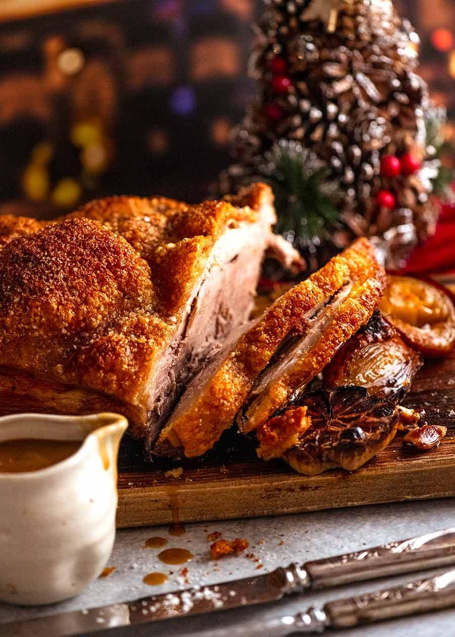 Juicy pork roast with crispy crackling skin and roasted potatoes