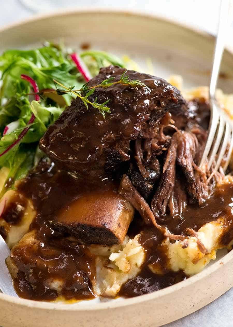 close up of beef short ribs marinating in red wine
