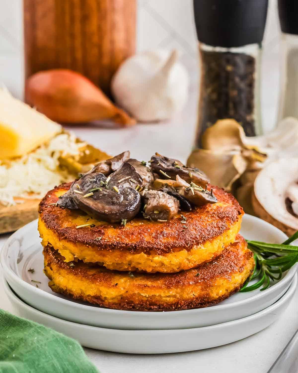 A rustic Italian kitchen setting with a plate of polenta cakes