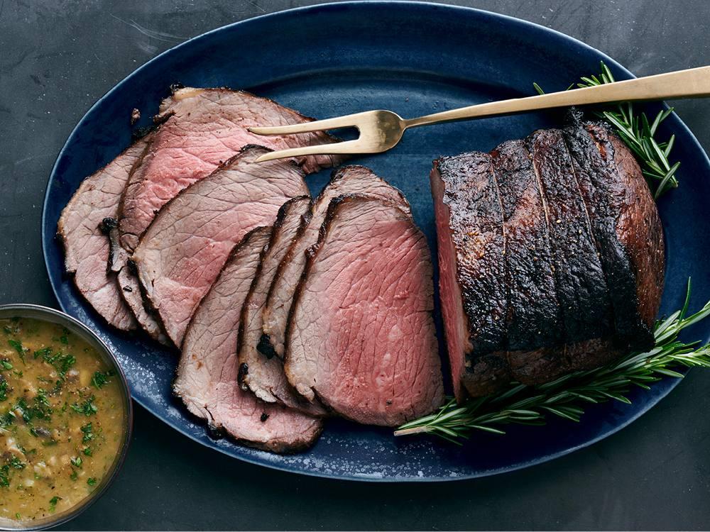 Close up of a juicy roast beef with rich mushroom sauce