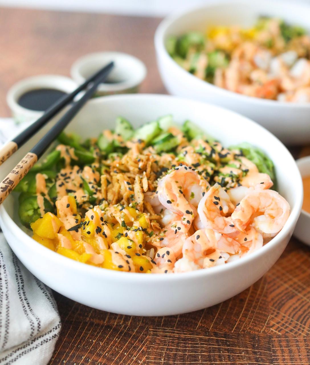 Close-up shot of a Dragon Roll Poke Bowl showing the vibrant colors and textures of the ingredients