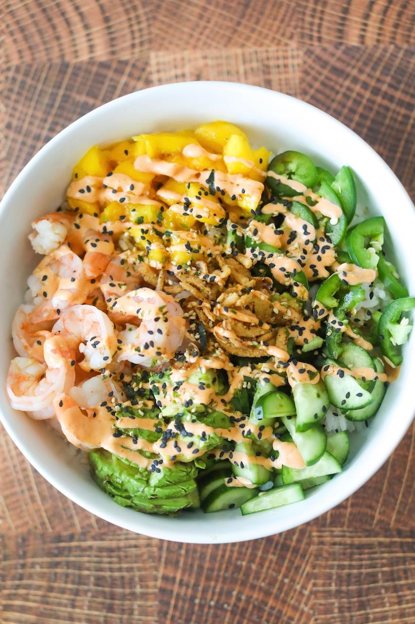 vibrant dragon roll poke bowl with colorful toppings