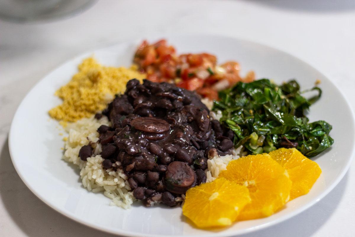 Close-up shot of the finished Feijoada dish with vibrant Mediterranean garnish