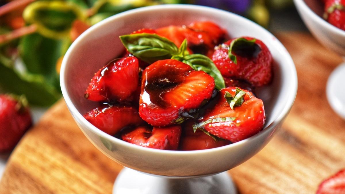 fresh strawberries and balsamic vinegar on a wooden table