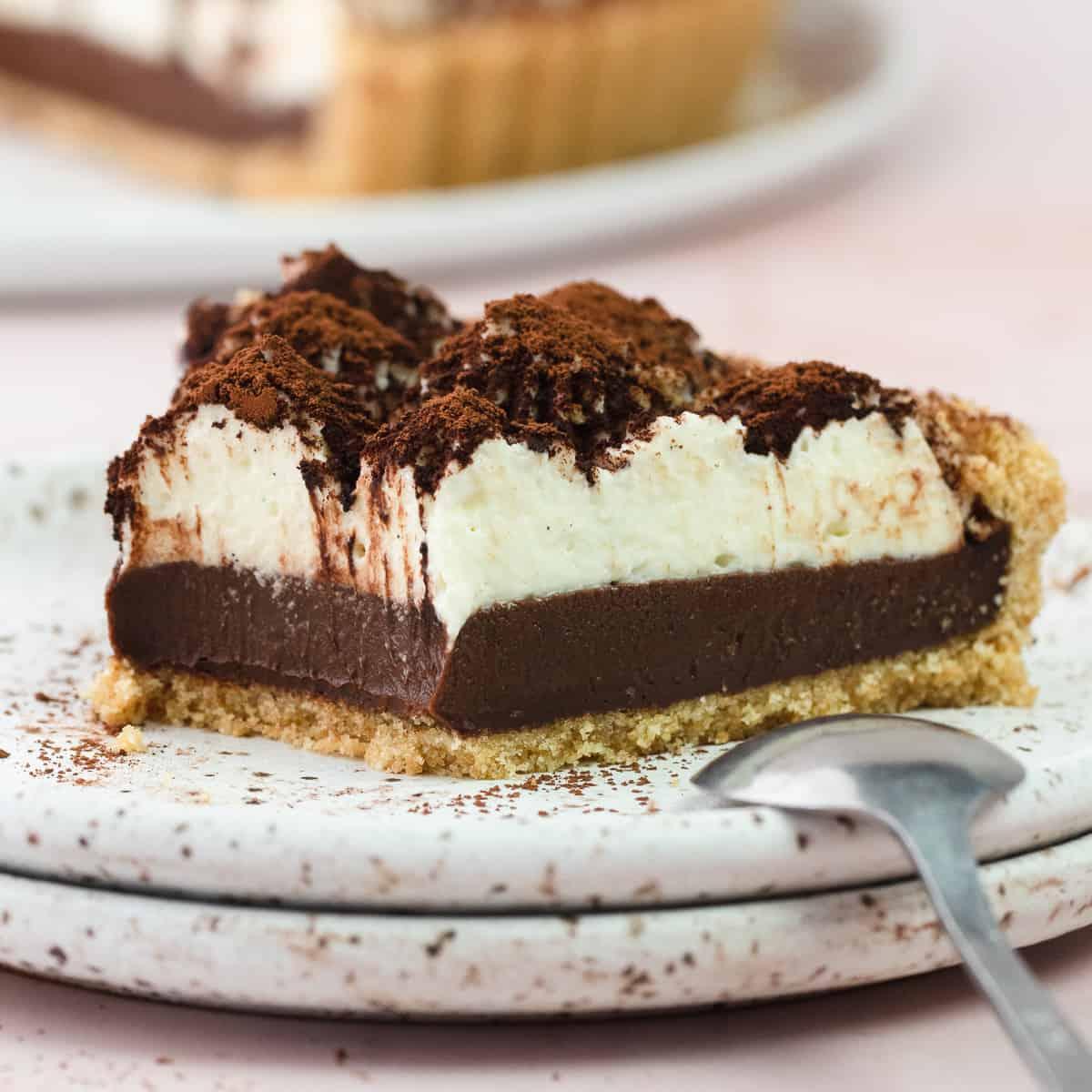 Close-up shot of a tiramisu tart with espresso cream and berry topping, showing the layers and texture