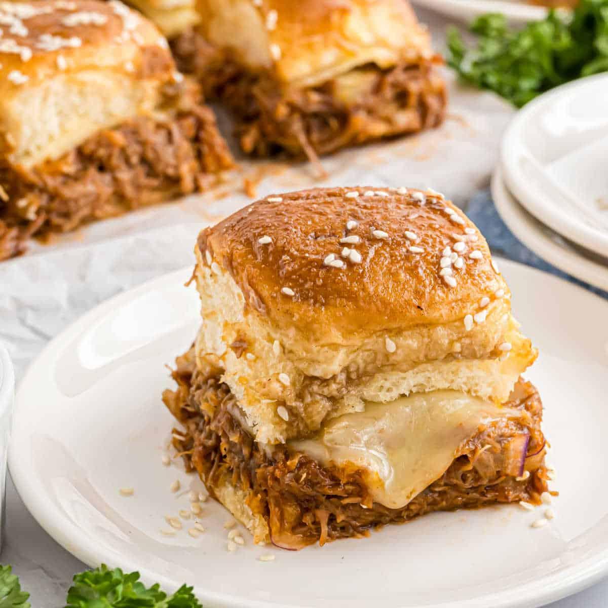 A plate of pulled pork victory sliders, showcasing the texture and detail of the ingredients