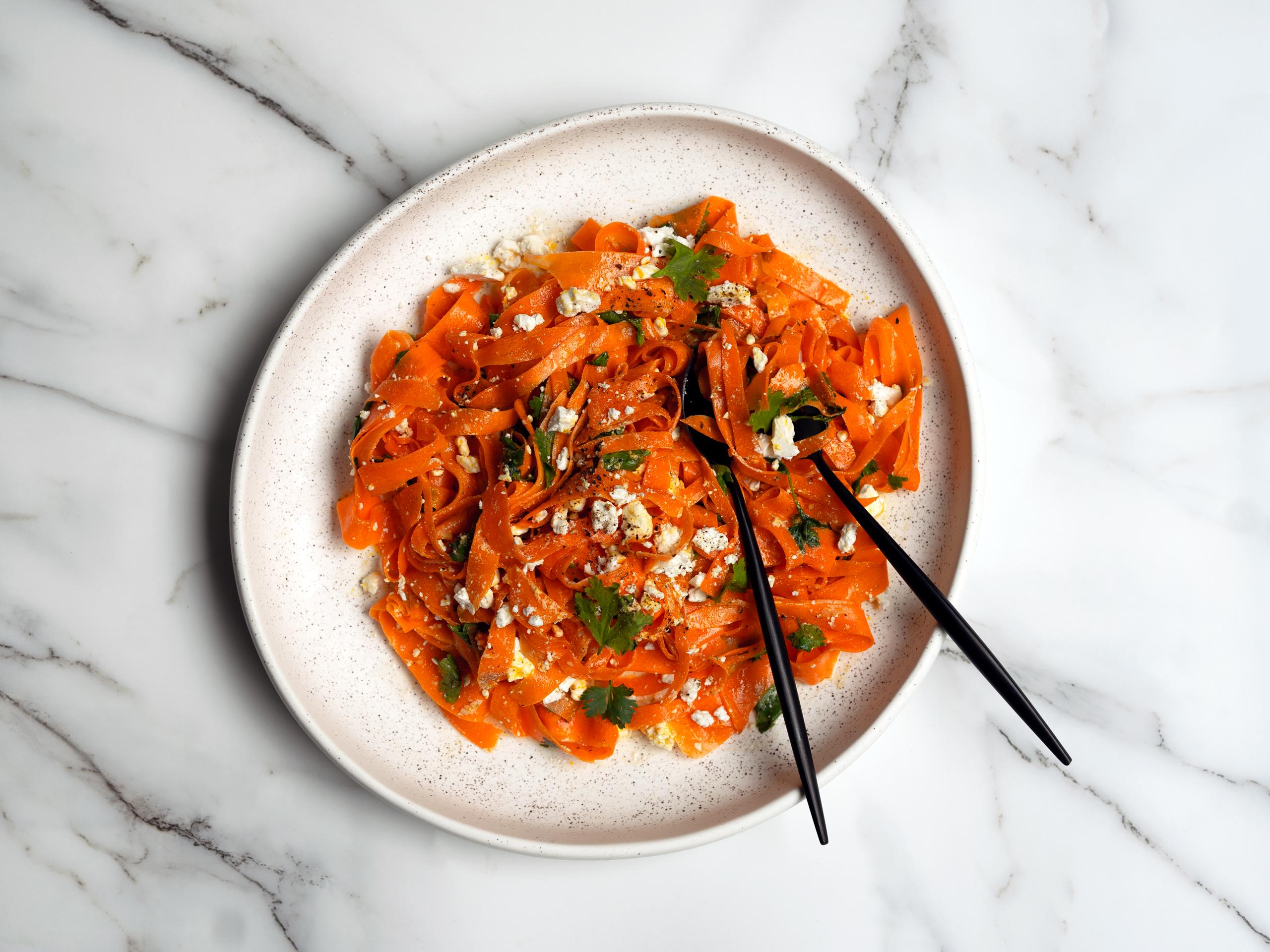 Close-up shot of a colorful Spicy Carrot & Ginger Fattoush salad in a rustic bowl.