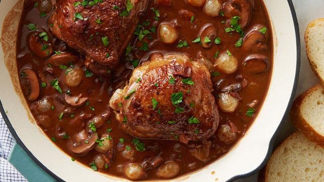cinnamon sticks and smoked paprika around a bowl of coq au vin