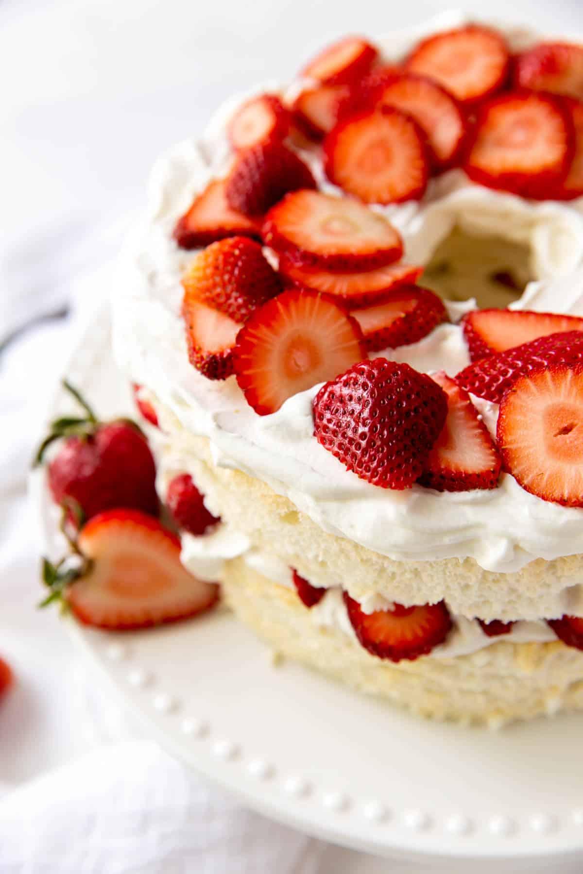 A beautifully presented angel food cake, sliced and ready to serve