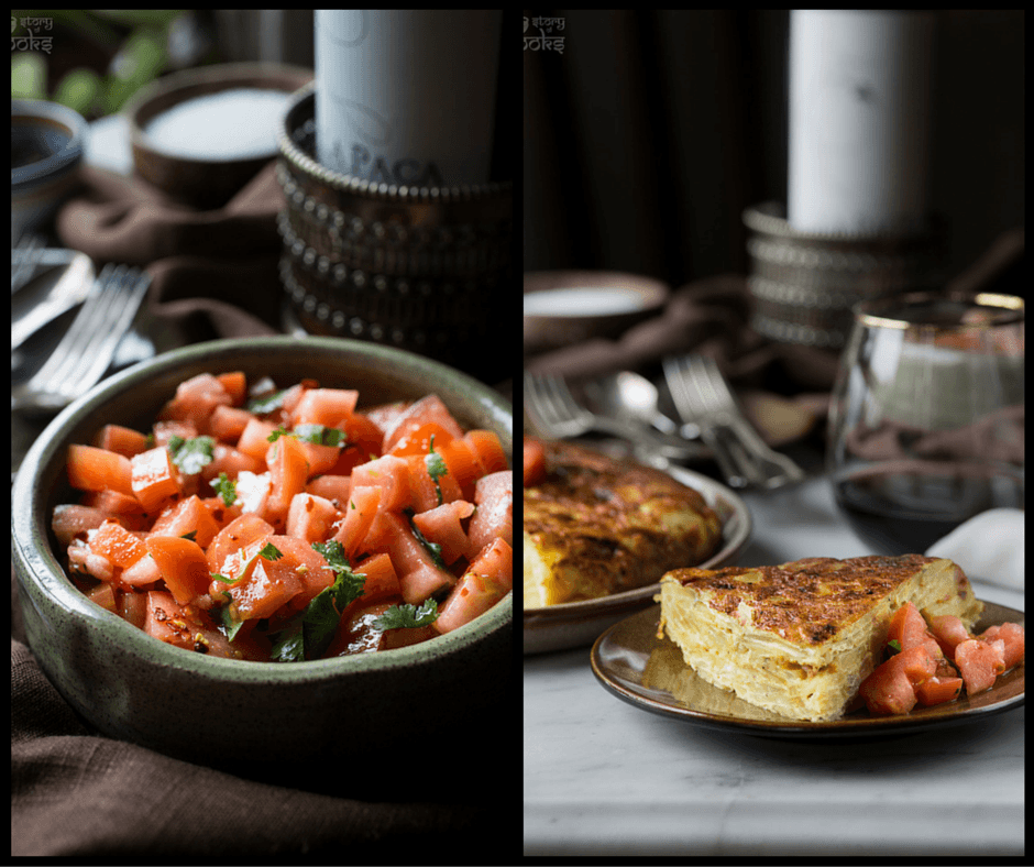 A rustic wooden table with a golden-brown Tortilla Española with sardines, garnished with fresh parsley