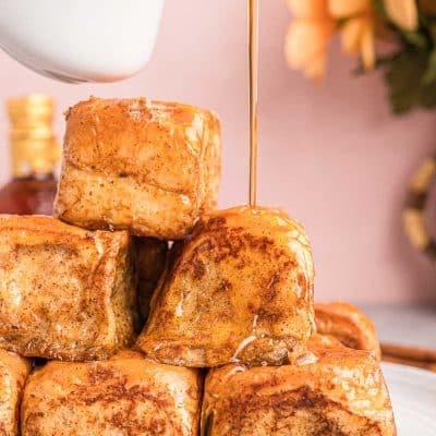 Close-up shot of mini French toast sliders with syrup drizzle