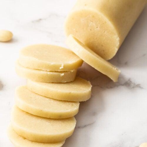 Close-up shot of homemade almond paste, showing its smooth texture and pale color