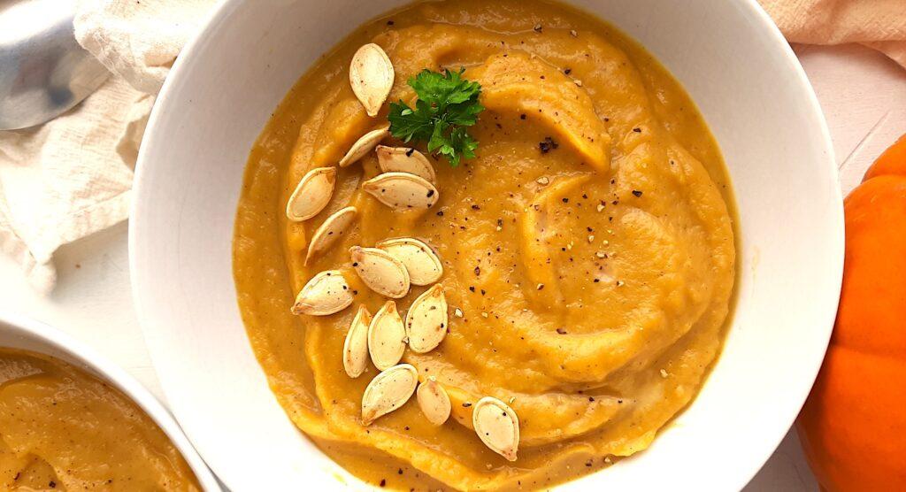 Close up shot of a bowl of pumpkin soup with sage and brown sugar