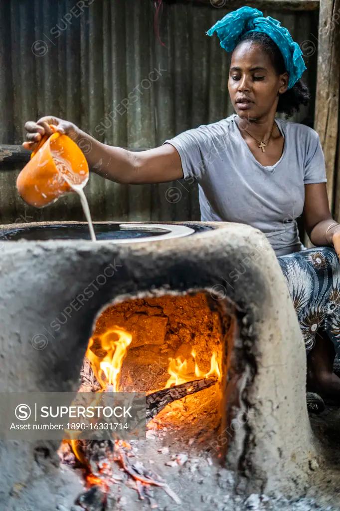 Ethiopian woman preparing injera bread