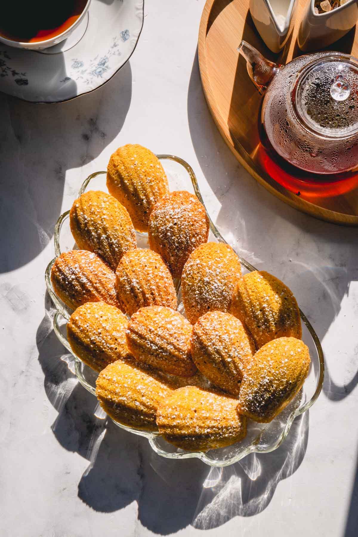 A close-up of a single Earl Grey madeleine, showing its delicate texture