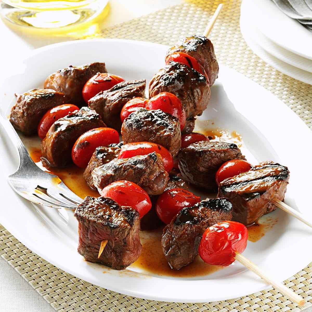 Close up of juicy beef kebabs glistening with balsamic glaze