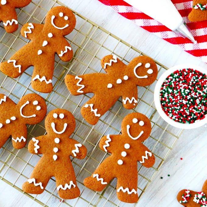 Overhead shot of Molasses Midnight Gingerbread Men on a cooling rack, some decorated, some plain