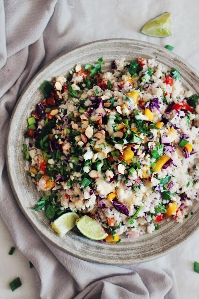 A person enjoying a bowl of the cauliflower rice salad