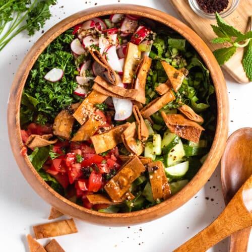 Ingredients for mint and peanut fattoush salad arranged on a wooden board