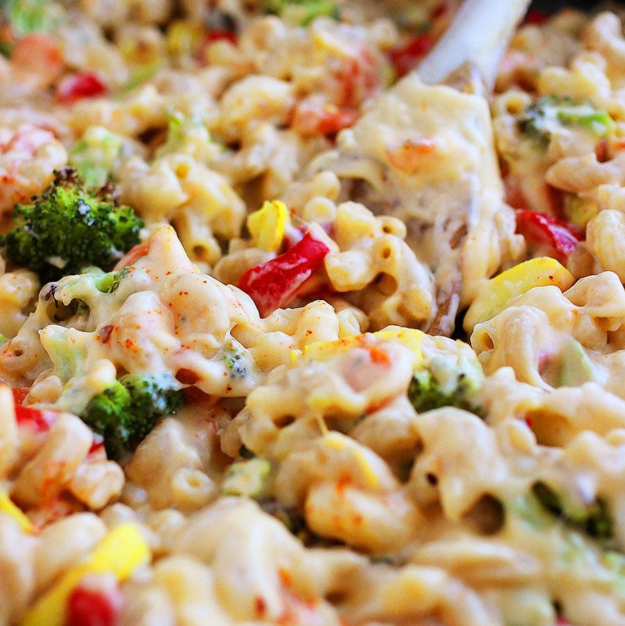 A family enjoying a meal of creamy mac and cheese with roasted vegetables