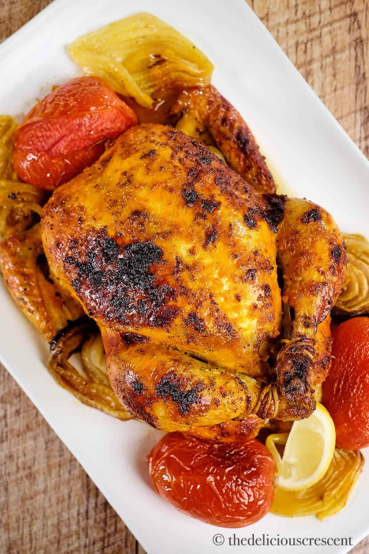 Golden roasted chicken with saffron-infused broth
