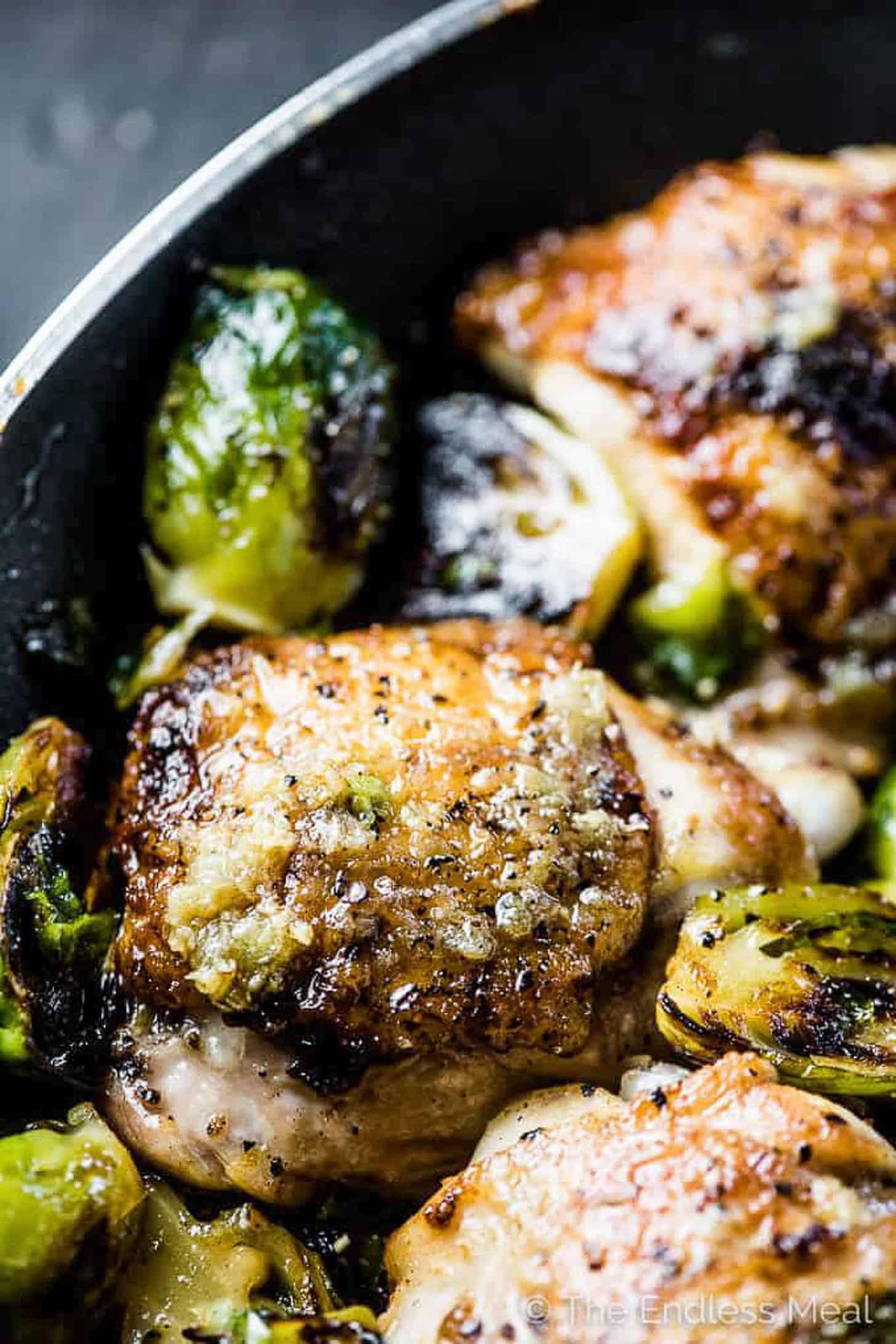 A family enjoying a meal of slow-cooked chicken and Brussels sprouts