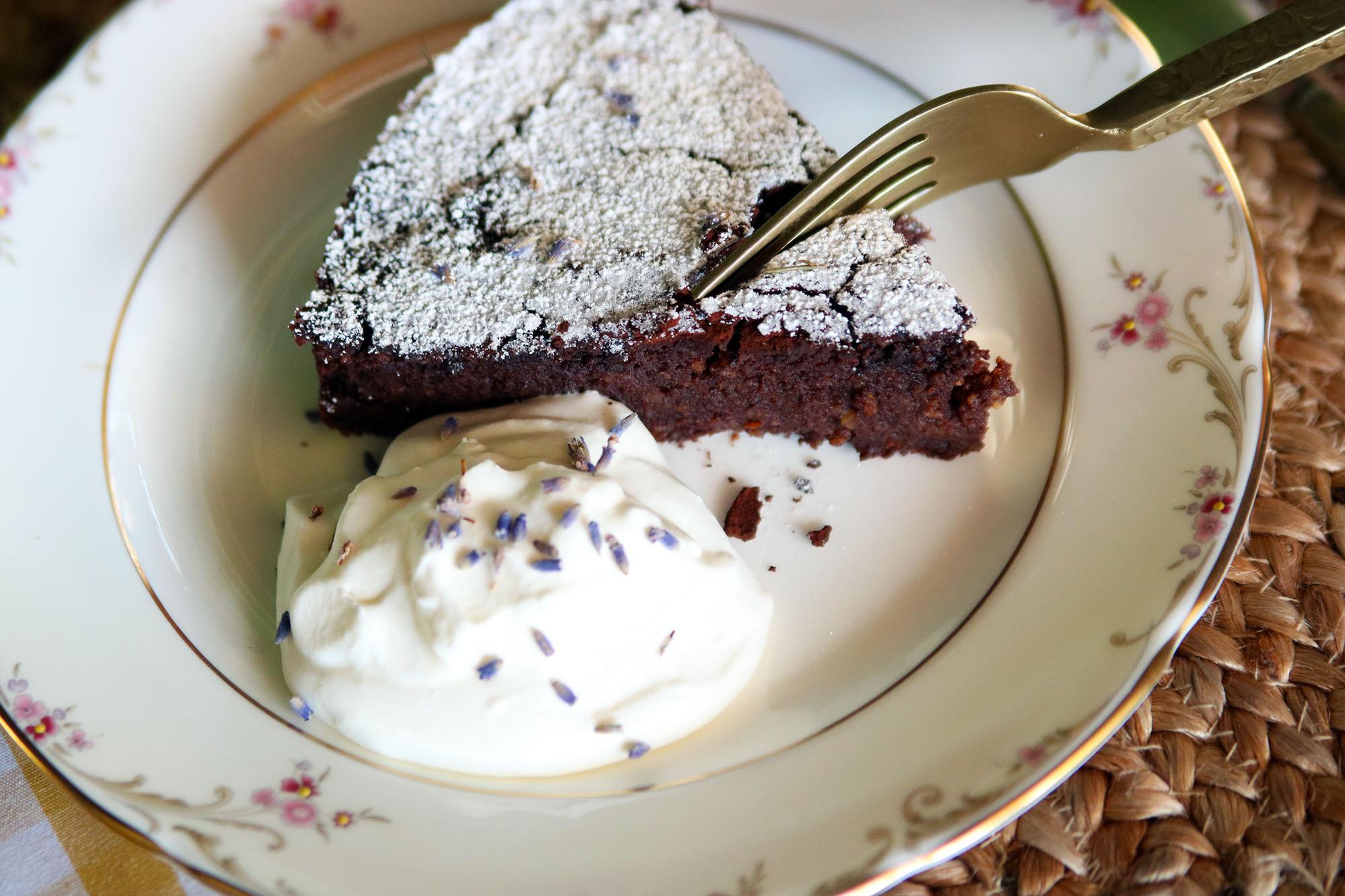 A whole polenta cake on a plate garnished with chocolate shavings