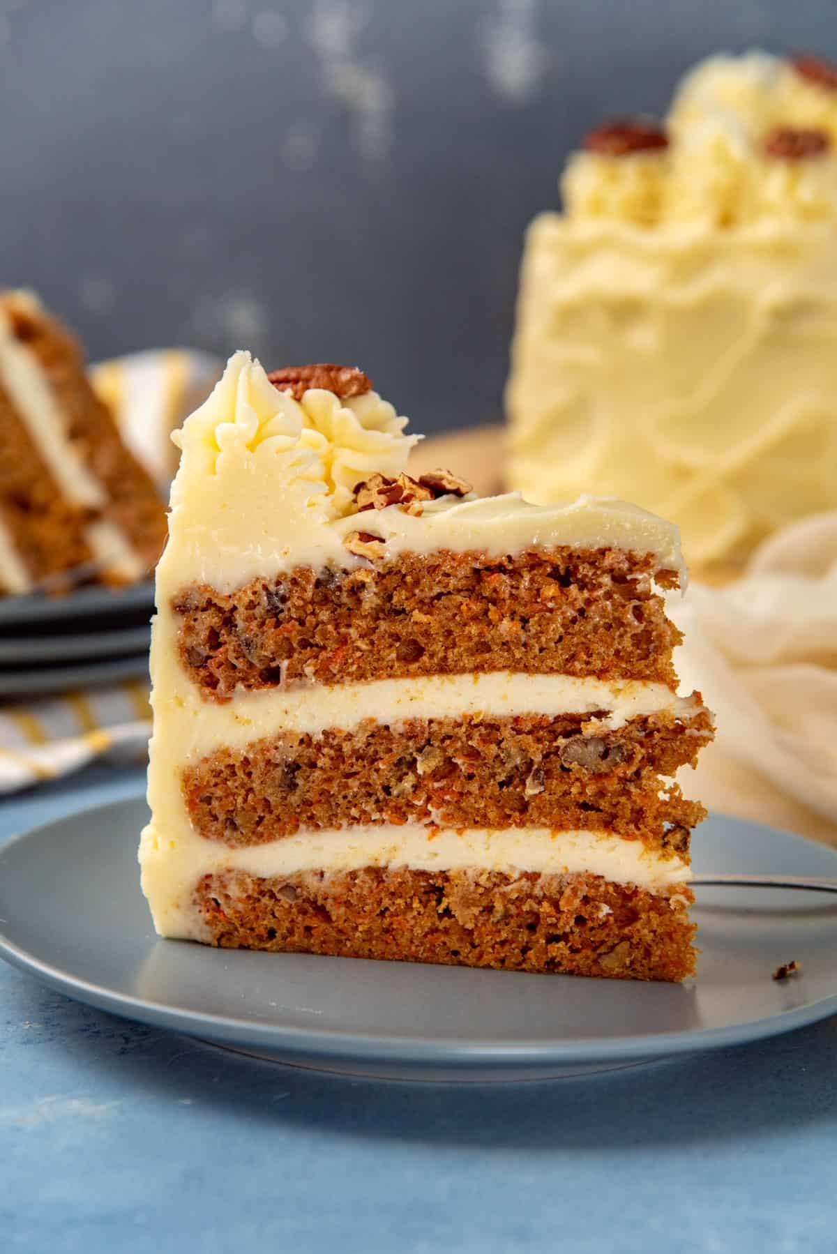 A delicious carrot cake sandwich, cut in half, showing layers of moist carrot cake and creamy cream cheese frosting.