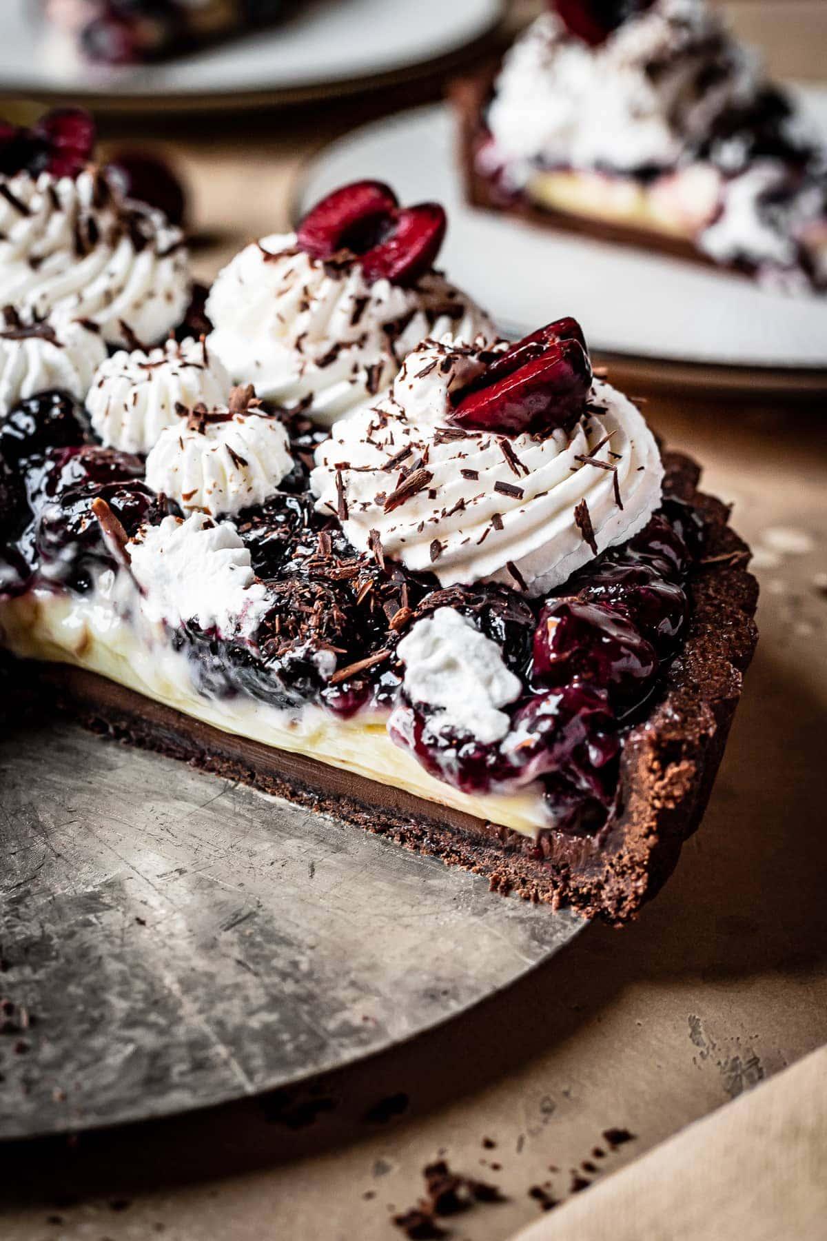 Close up of a slice of cherry chocolate tart