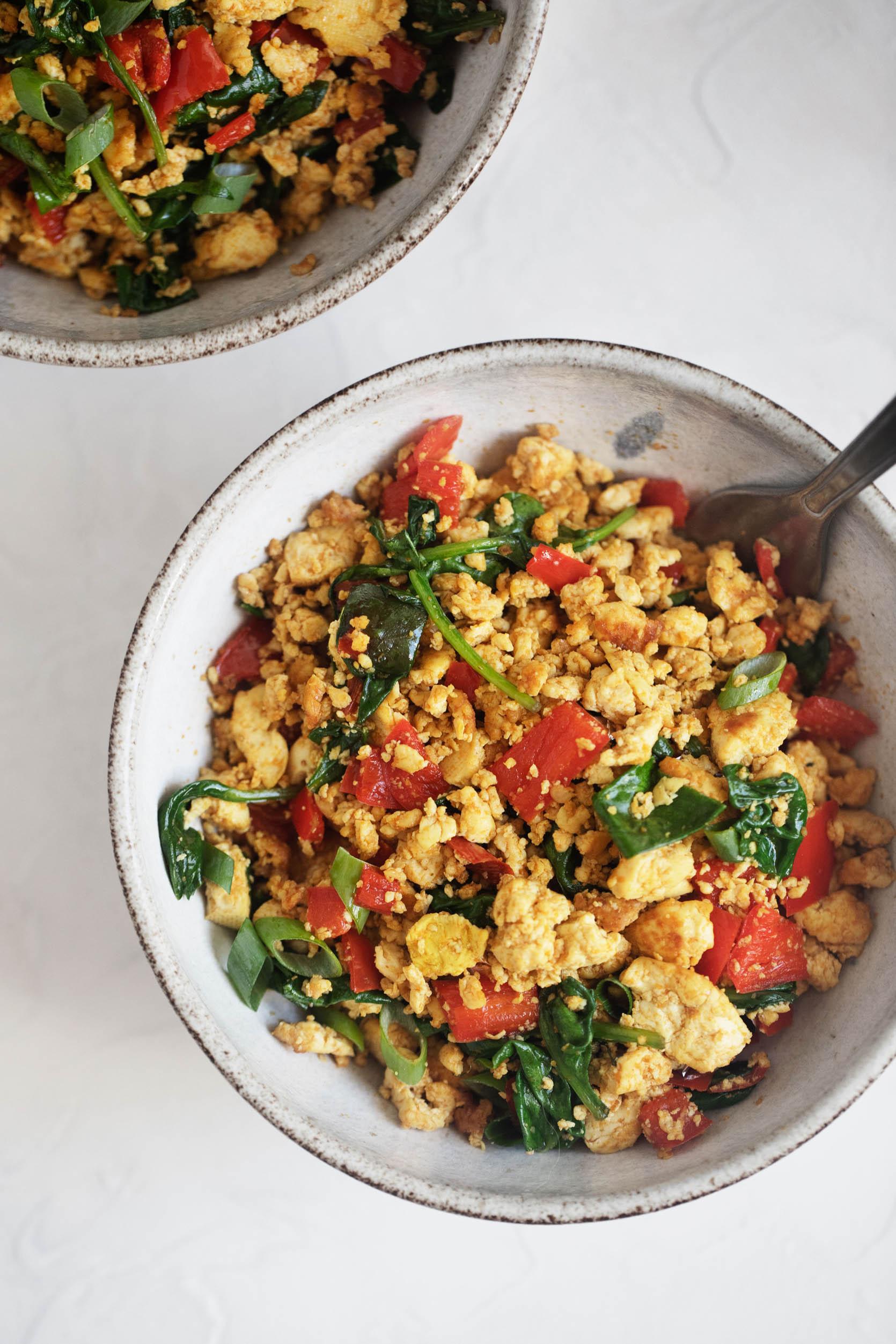 A side shot of a person enjoying fluffy tofu scramble for breakfast