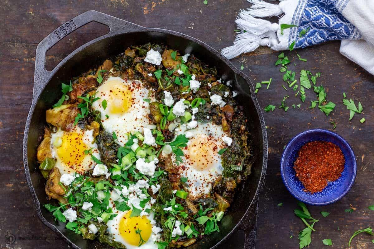 A vibrant and appetizing image of shakshuka with a side salad, showcasing the rich colors of the dish and the fresh greens of the salad.