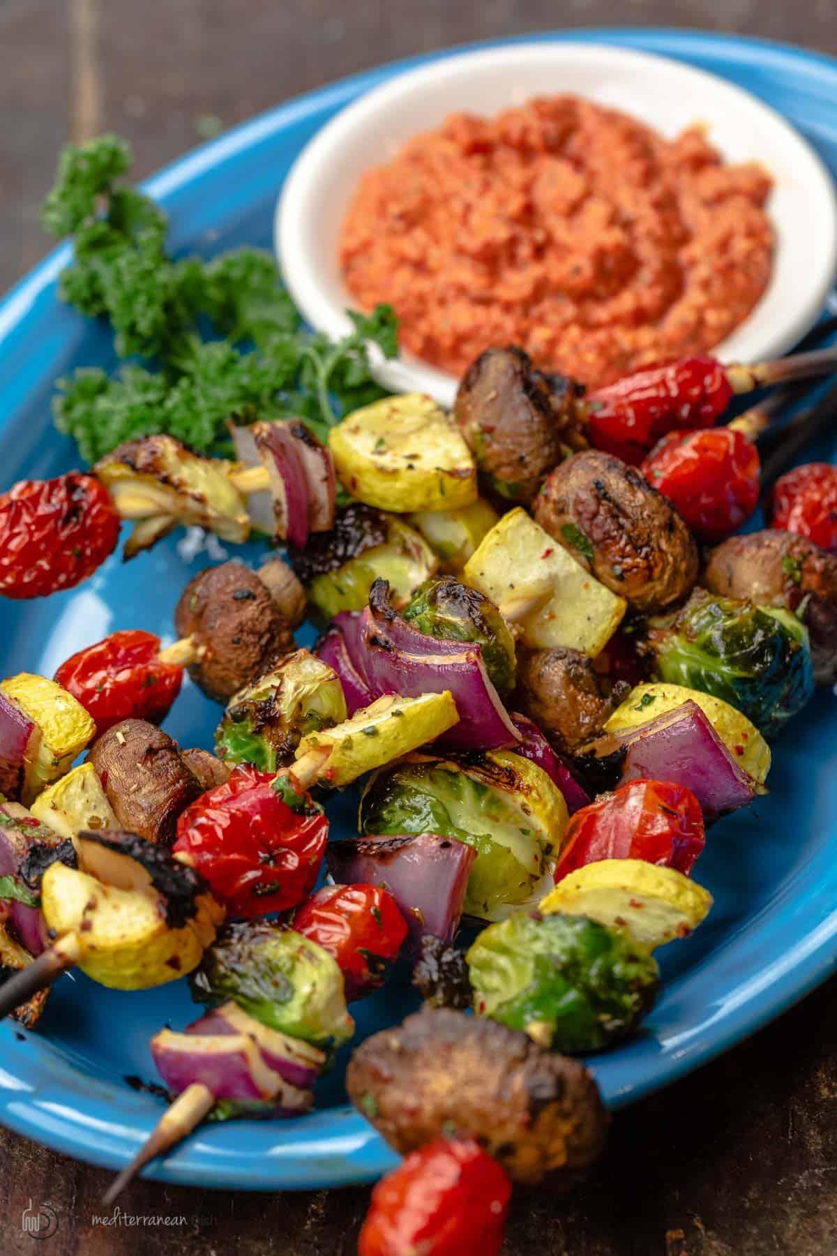 A plate of vegetable sticks with different seasonings sprinkled on top